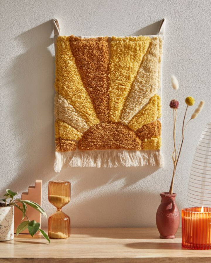 Retro wall art hanging with a yellow sun