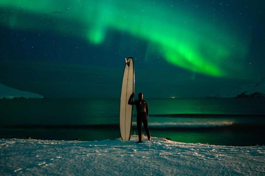 surfing under the northern lights iceland