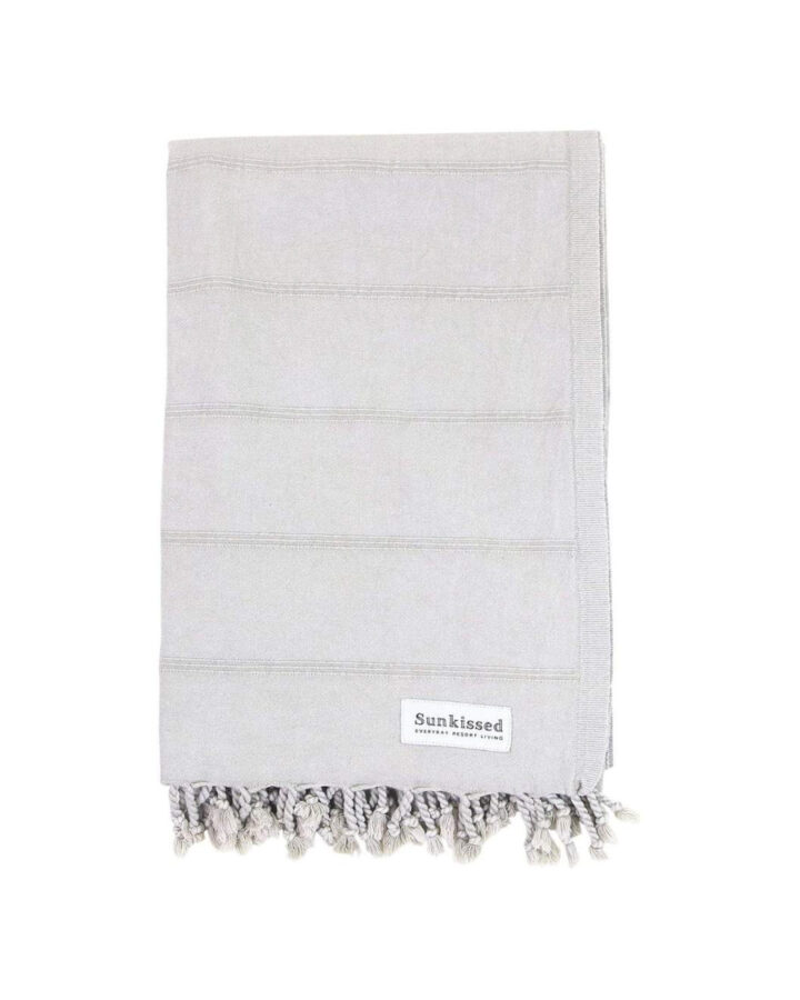 light grey turkish beach towel on her head