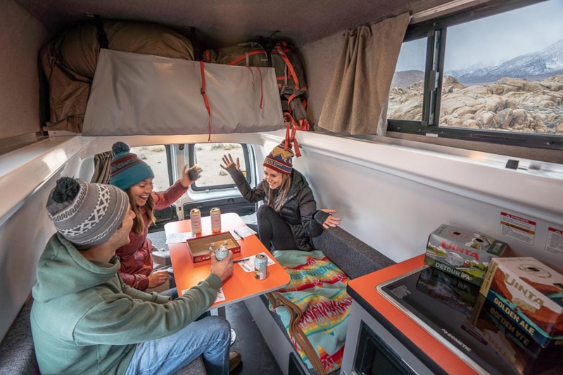 friends enjoying inside a camper van