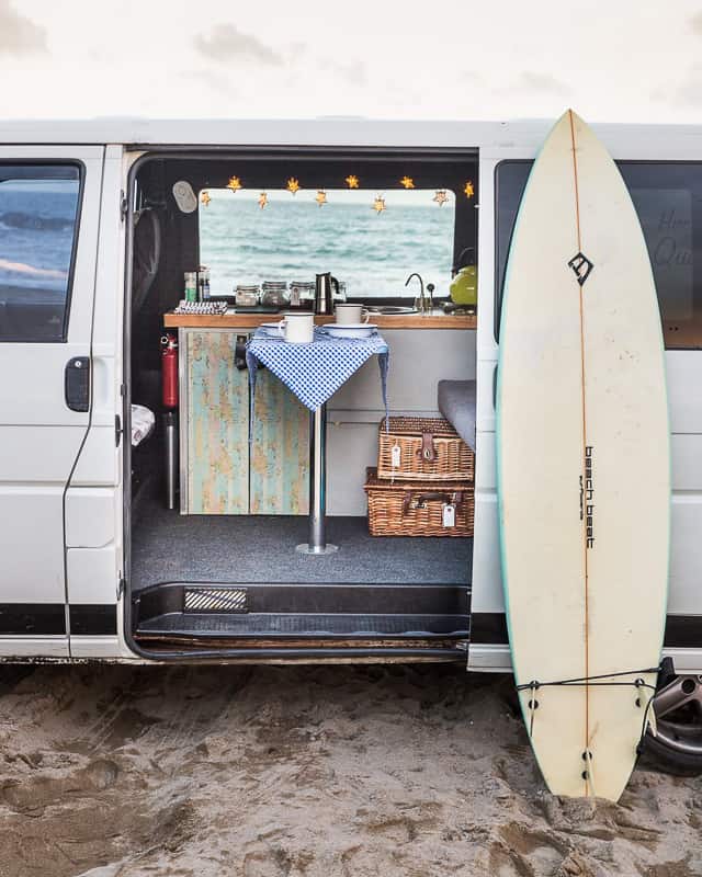 campervan hire uk quirky campers van with surfboard and table set up