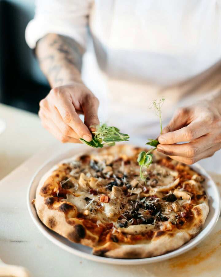 private chef preparing craft pizza for corporate retreat
