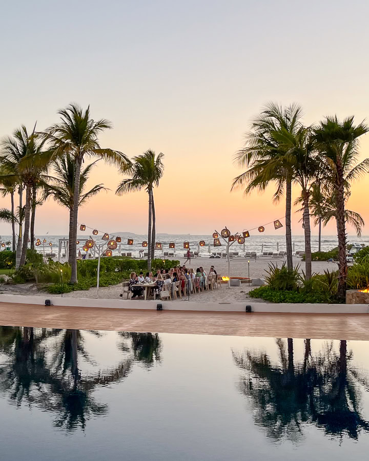 executive retreats group dinner at sunset on beach