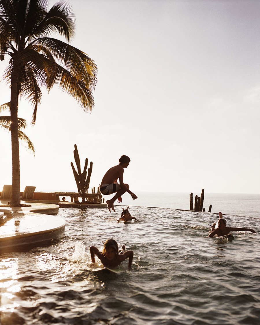 luxury surf vacation with kids playing in the pool