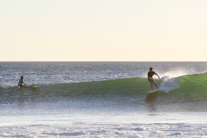 girl surfing midlength going right on green wave