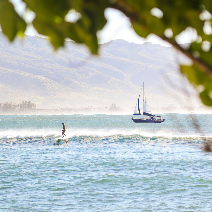 sailboat and surfer hawaii surf trip