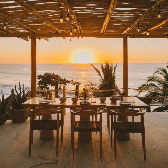 luxury surf retreat dinner with sunset view