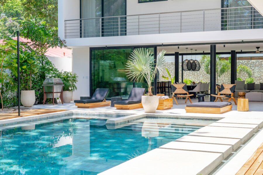 private pool surrounded by plush lounge chairs