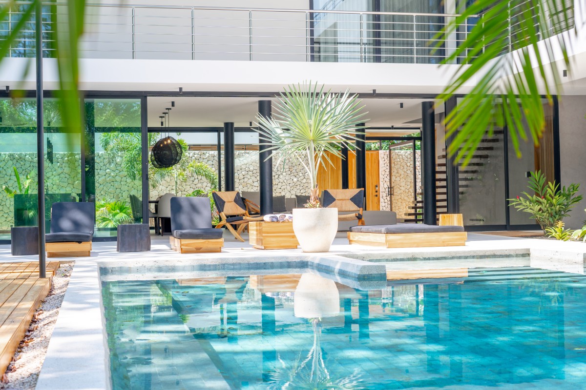 tranquil pool with reclining chairs and tropical surroundings