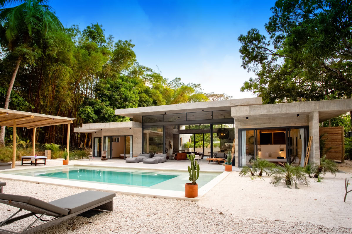 A modern villa with a private pool surrounded by tropical trees