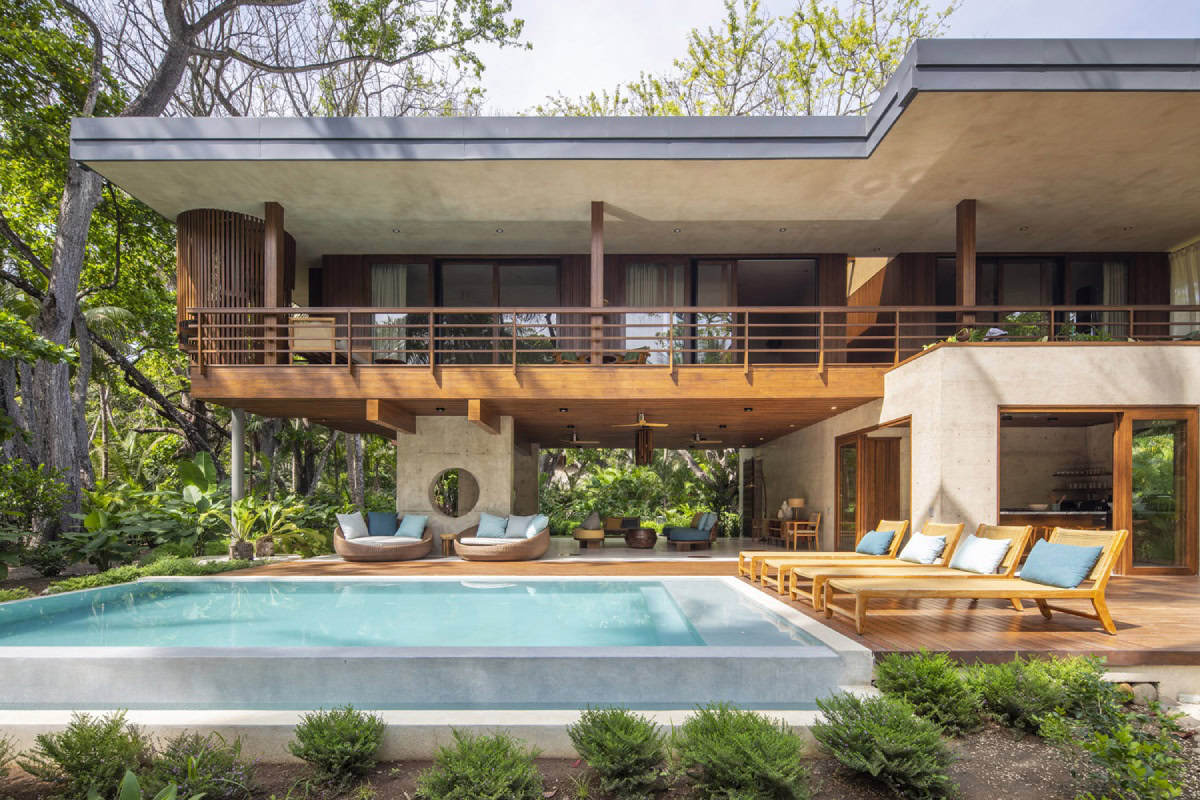 luxury beachfront villa with infinity pool and lounge chairs