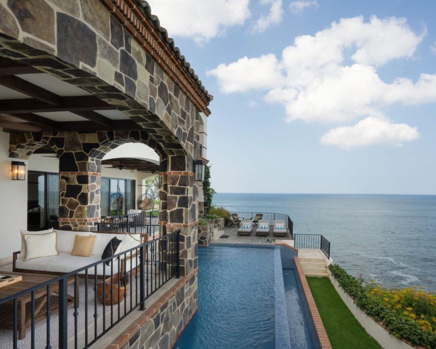 luxurious stone balcony with an infinity pool overlooking the ocean
