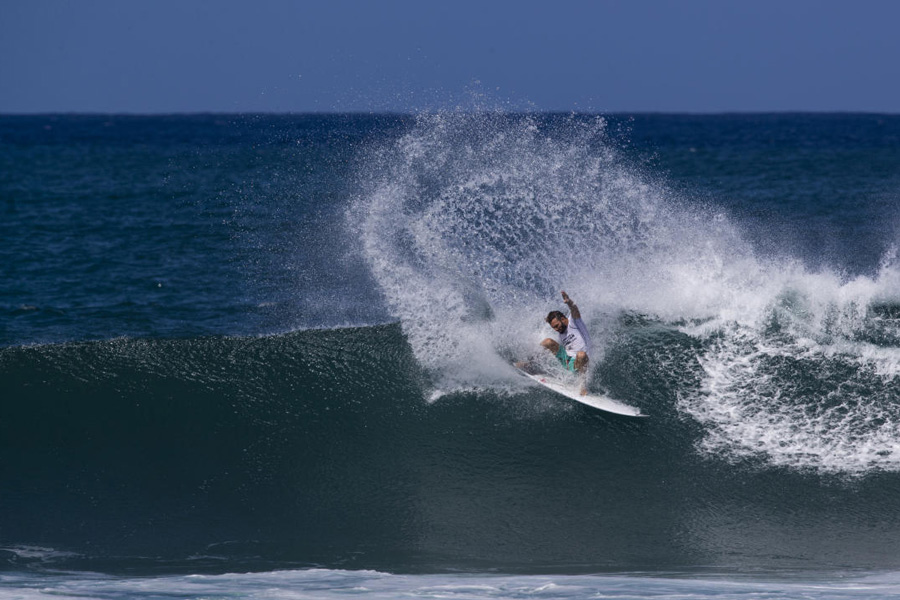 Surfer surfing a wave at The Hawaiian Pro in North Shore, Oahu