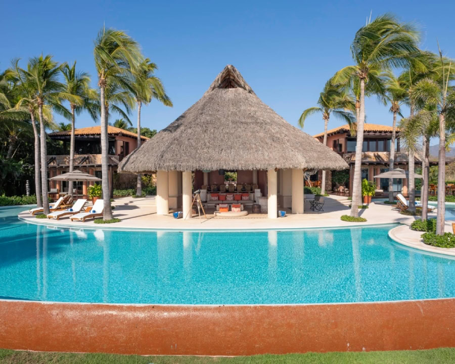 luxury tropical villa with poolside cabana, surrounded by palm trees in Costa Rica.