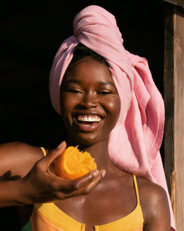 woman wearing pink beach towel wrapped around her hair