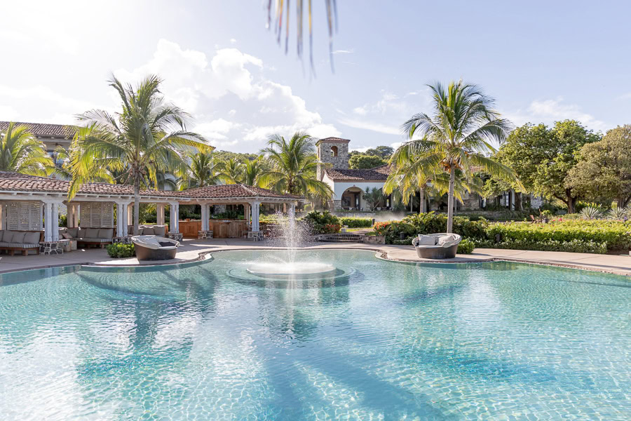 Infinity pool at Rancho Santana with palm trees