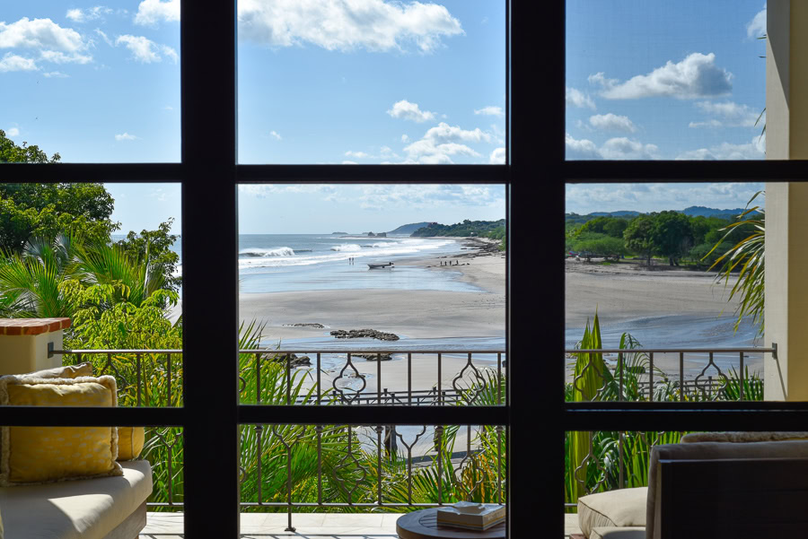 Beach and waves viewed through Rancho Santana balcony window.