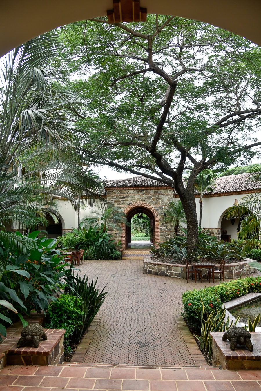 Rancho Santana courtyard with lush greenery and archway