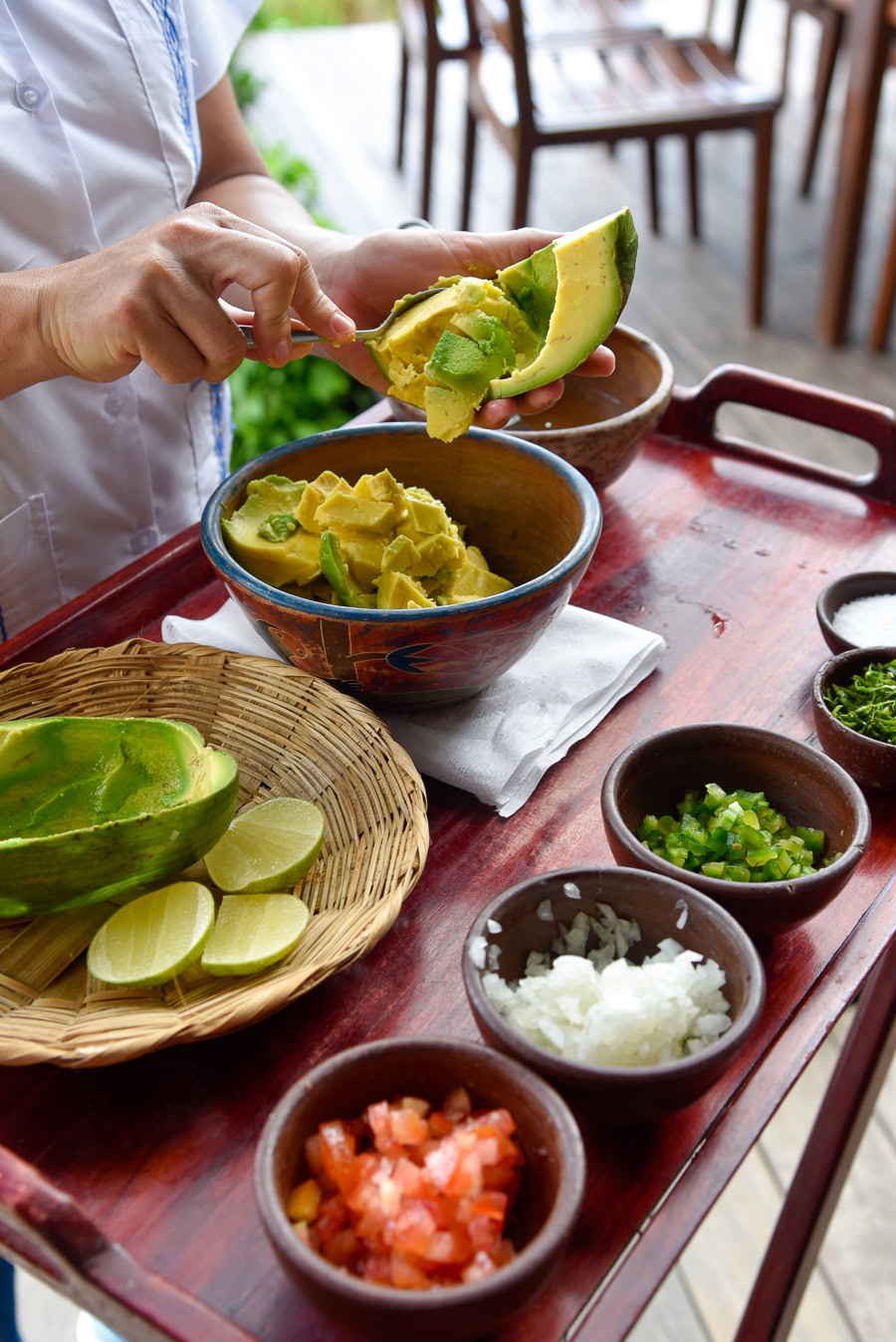 Fresh guacamole prepared tableside with vibrant ingredients.