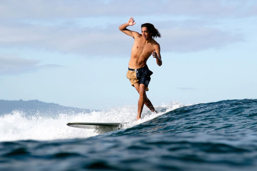 Surfer longboarding in Katin boardshorts