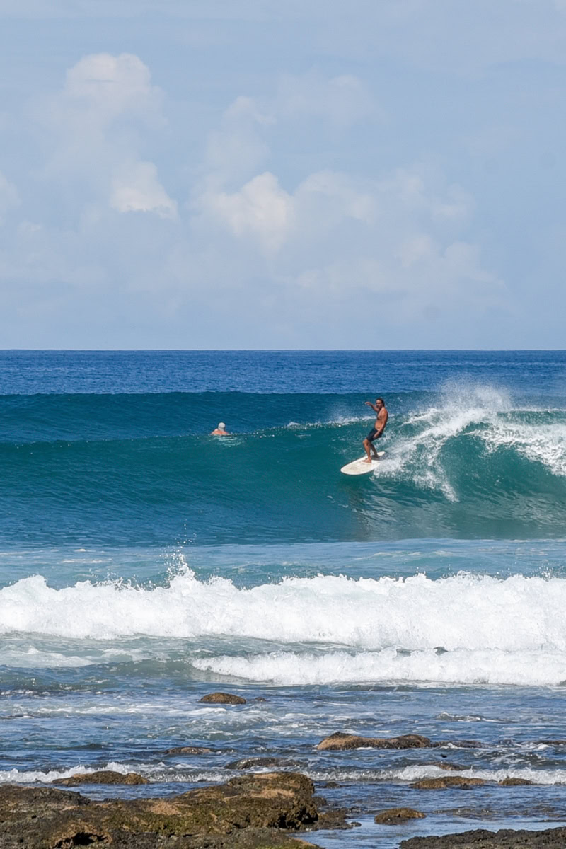 stylish surfer on fun right breaking wave in Costa Rica