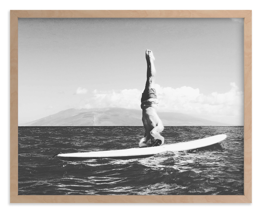 Vintage style surf photo of a man doing a shoulder stand on a surfboard